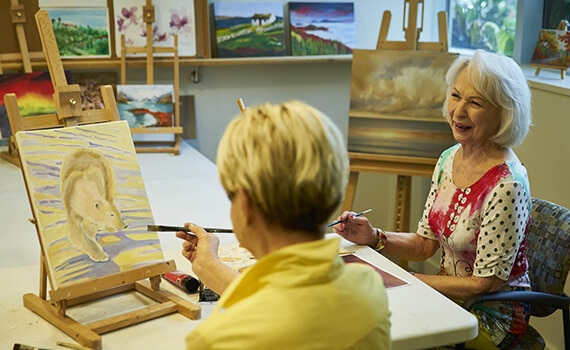 Residents painting in the art studio