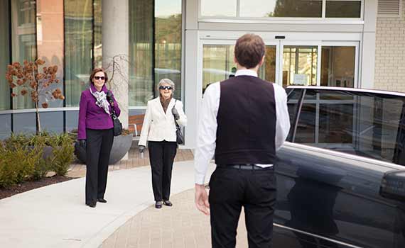 Two residents about to get into chauffeur vehicle