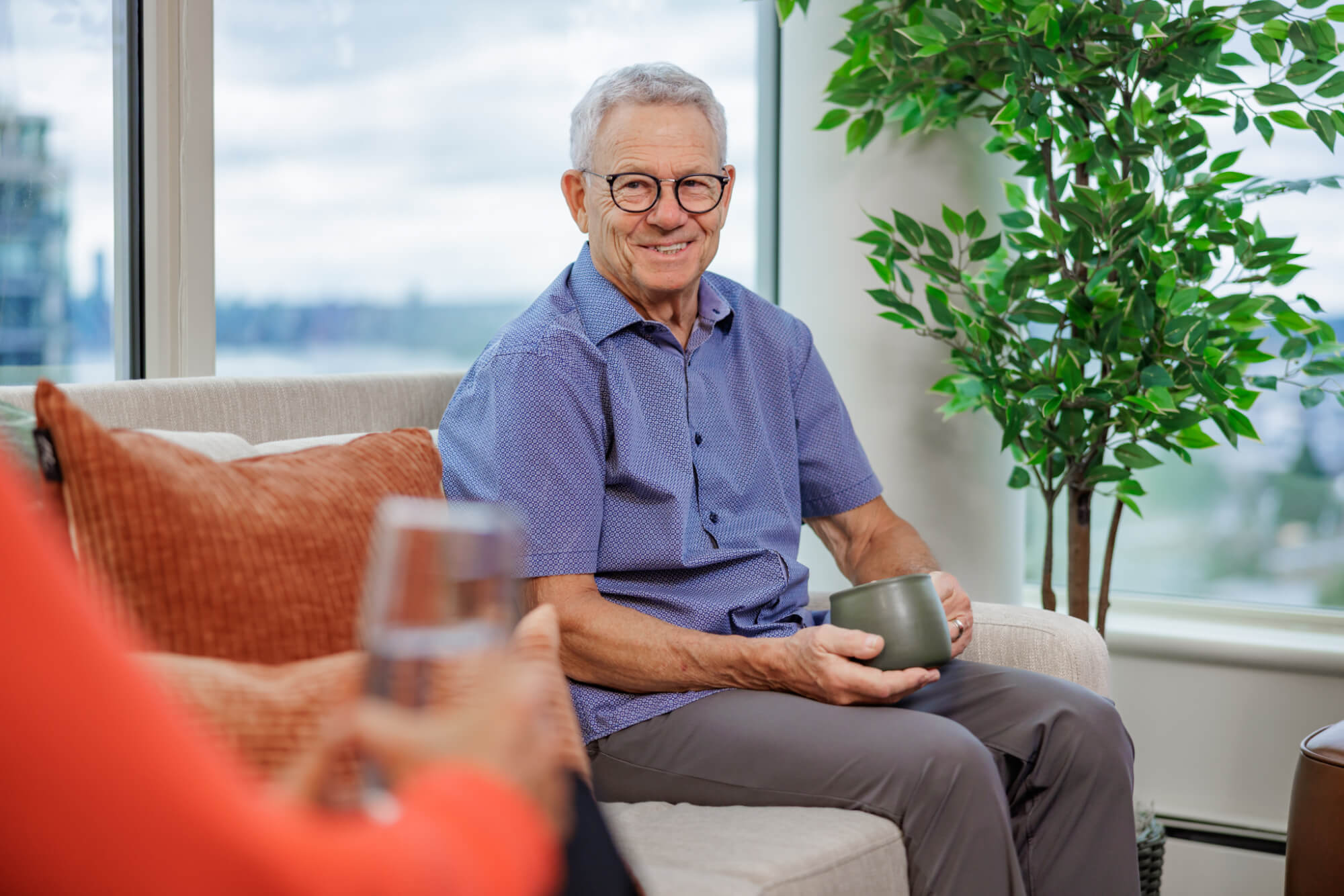A resident enjoying some coffee in a living room