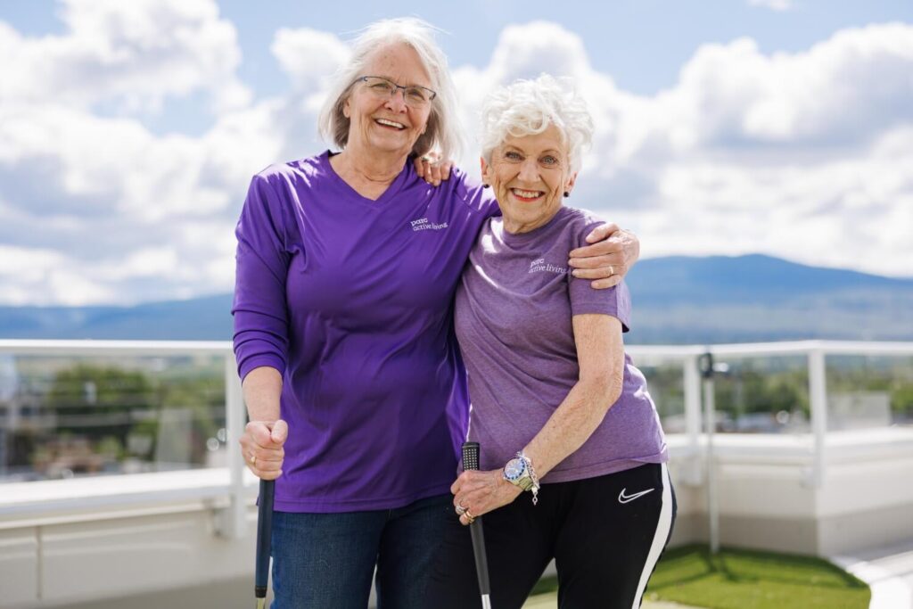 Two women standing together and smiling